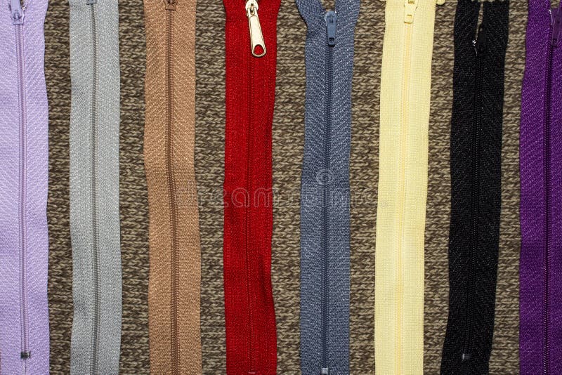 Background of multi-colored zippers for clothes. Zipper with lock for clothes and accessories.Background of multi-colored zippers for clothes royalty free stock photos