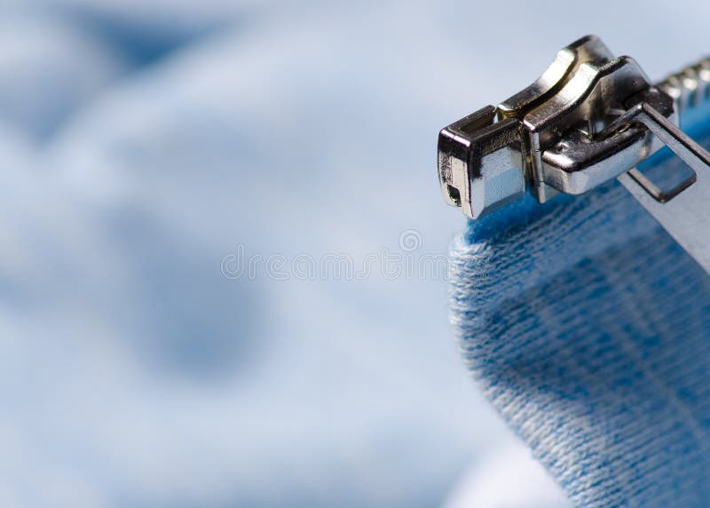 Blue fabric clothes zipper lock shirt macro. Blue white fabric clothes zipper lock shirt macro blurred background royalty free stock photos