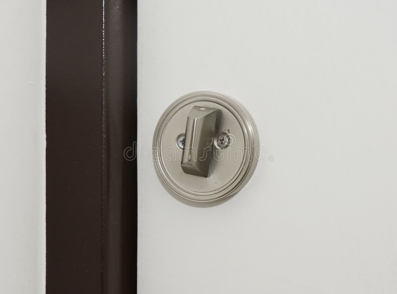 A close-up on a white door with round flush pull privacy kit, sliding pocket door bathroom lock. Image stock photography