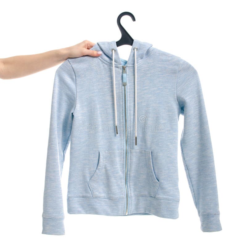 Clothes blue sweatshirt on the lock on a hanger female hand. Isolation on a white background stock photography