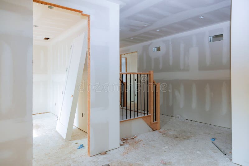 Finishing putty in the room walls plasterboards with room under construction. Walls plasterboards with room under construction with finishing putty in the room stock images