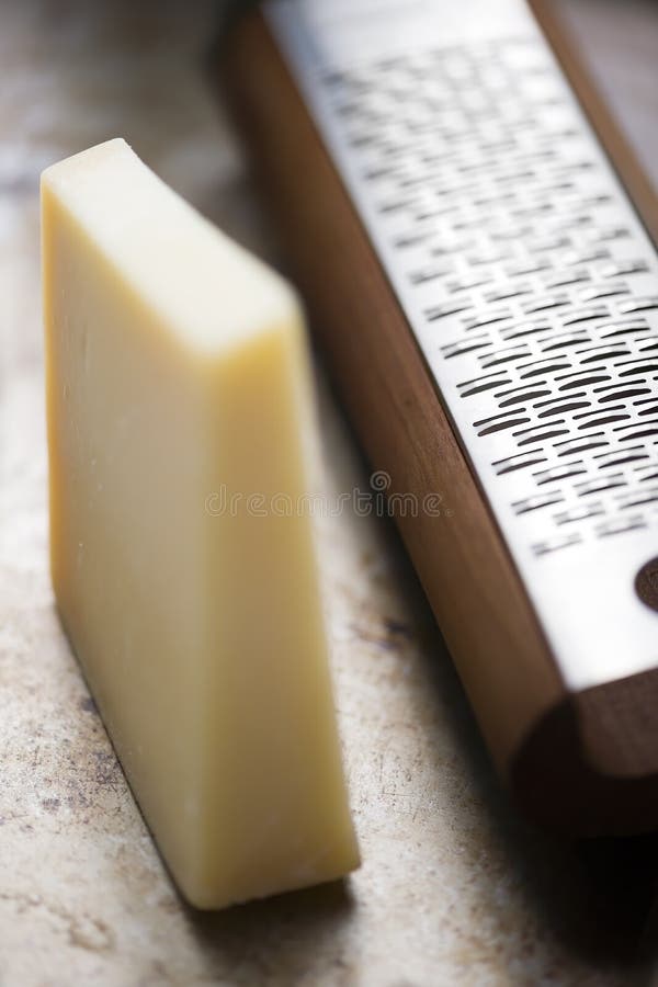 Italian cheese dairy with grater. Rustic italian cheese dairy with grater royalty free stock photos