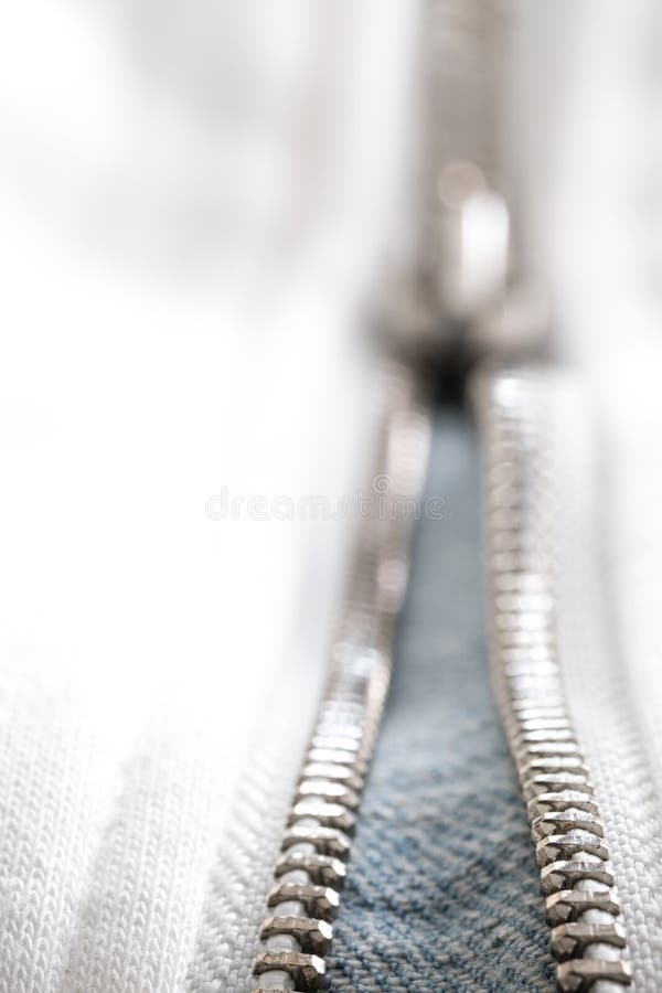 Jeans white zipper and lock closeup detail view. White zipper and lock closeup detail view royalty free stock image