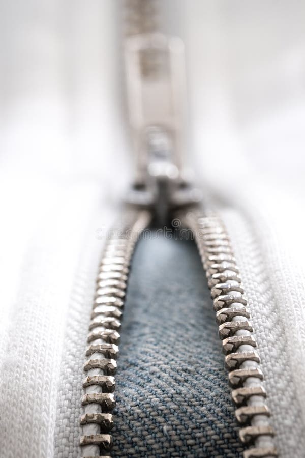 Jeans white zipper and lock closeup detail view. White zipper and lock closeup detail view stock photography