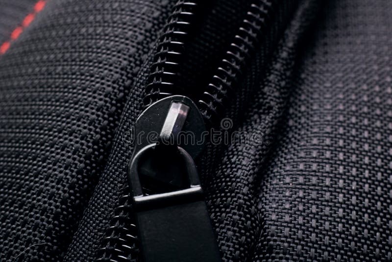 Lock and zipper on black fabric close up. Macro photo royalty free stock photography