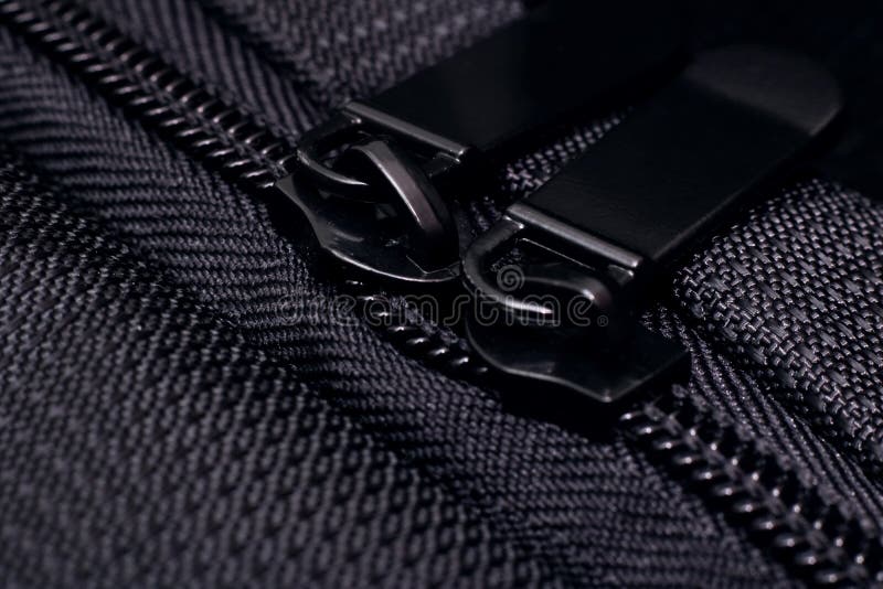 Lock and zipper on black fabric close up. Macro photo stock photo