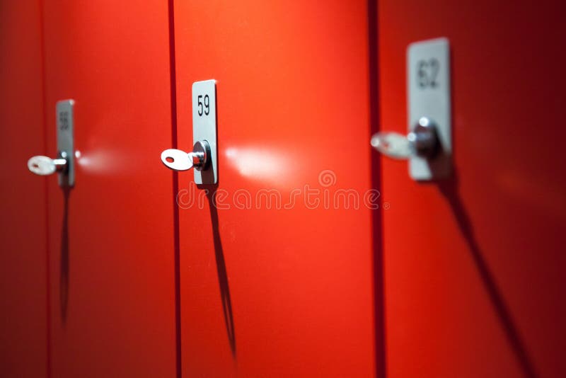 Lockers for clothes in detail. Red lockers, storing clothes for free, locker for clothes at lock, public lockers, key in cabinet stock photos