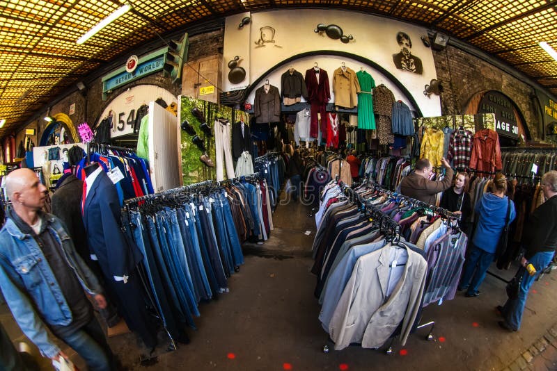 London, United Kingdom - March 31, 2007: Extreme wide angle fisheye photo, unknown shoppers checking clothes in one of many. Stalls at Camden Lock, famous flea royalty free stock photos