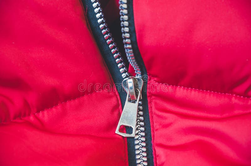 Metallic zipper on a red women`s jacket. stock photography