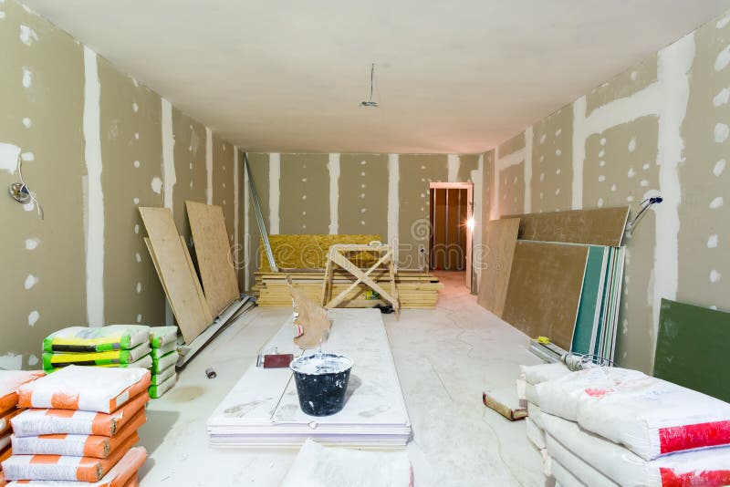 Materials for construction putty packs, sheets of plasterboard or drywall in apartment is under construction, remodeling. Renovation, extension, restoration royalty free stock images