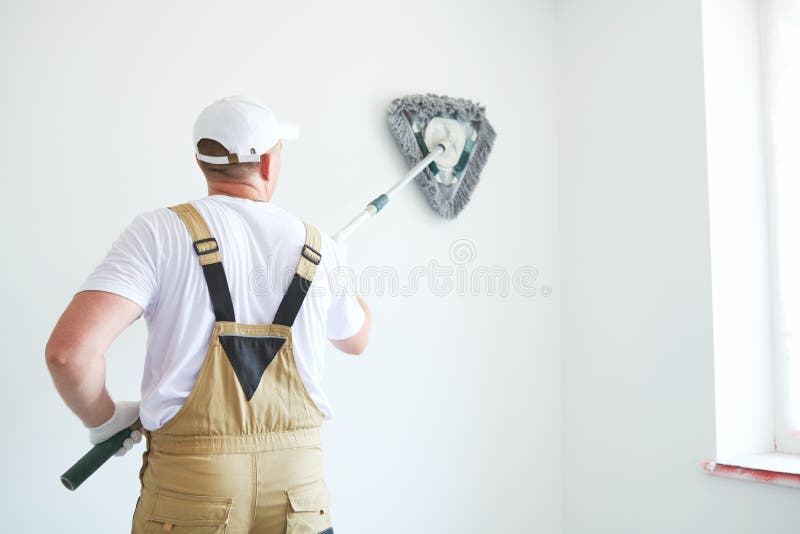 Painter works with triangle drywall cleaning tool. Surface preparation for painting. Painting preparation at home impovement. Painter cleaning drywall after royalty free stock photos