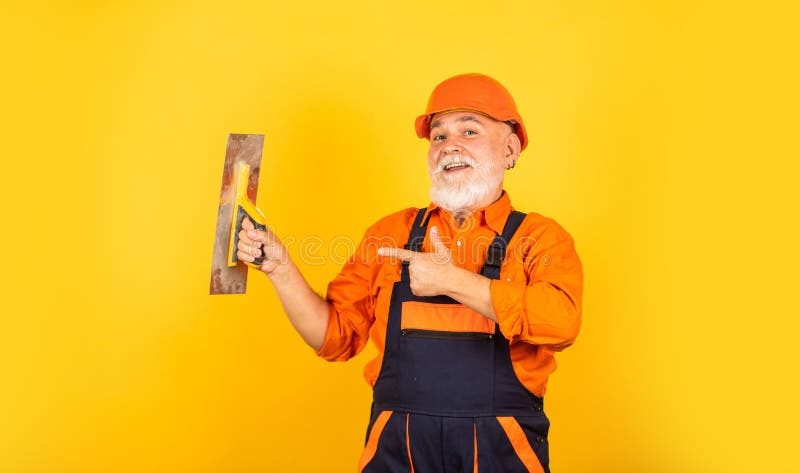 Process of applying layer of putty. Plastering tools for plaster. plaster trowel spatula on yellow drywall plasterboard. Plasterer in working uniform royalty free stock photos