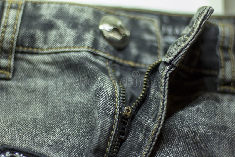 Quilted zipper lock jeans close-up. Quilted zipper lock and siver button of jeans close-up stock image