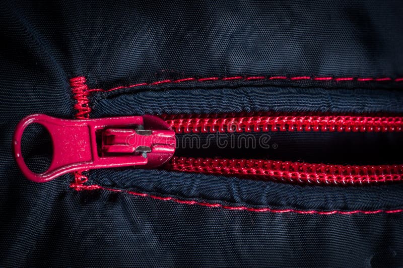 Red zipper clasp with lock on the bag blue, close-up.  royalty free stock image