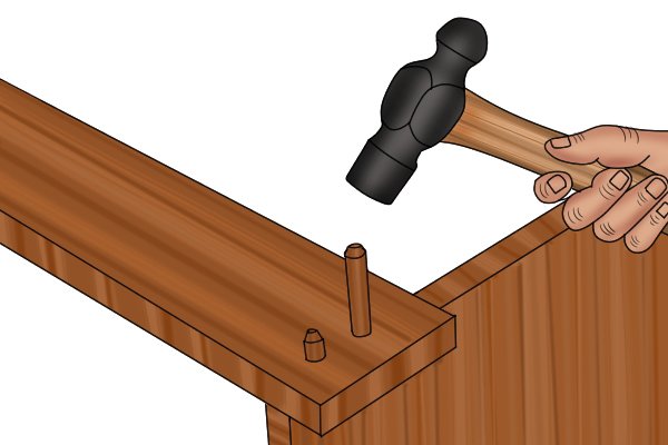 Image of a joint where the dowels are visible because the DIYer drilled too far through the wood