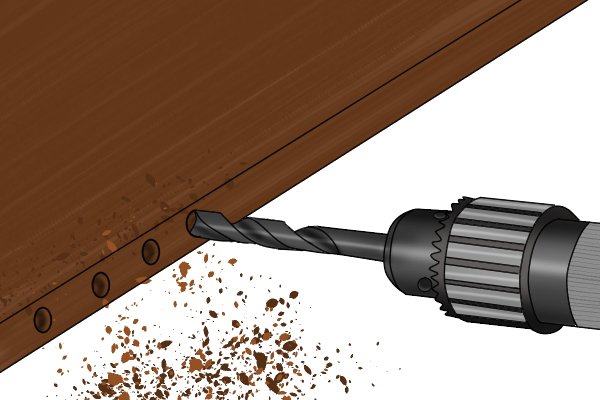 DIYer drilling a dowel hole with a power drill