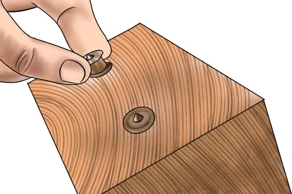 Inserting centre points into pre-drilled dowel holes to make a wooden joint